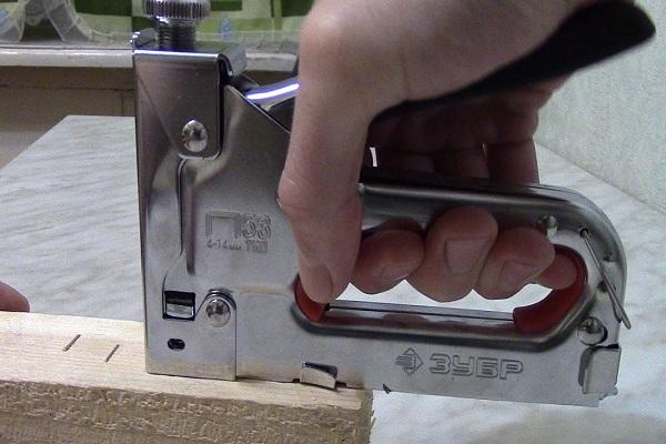 à l'aide d'une agrafeuse